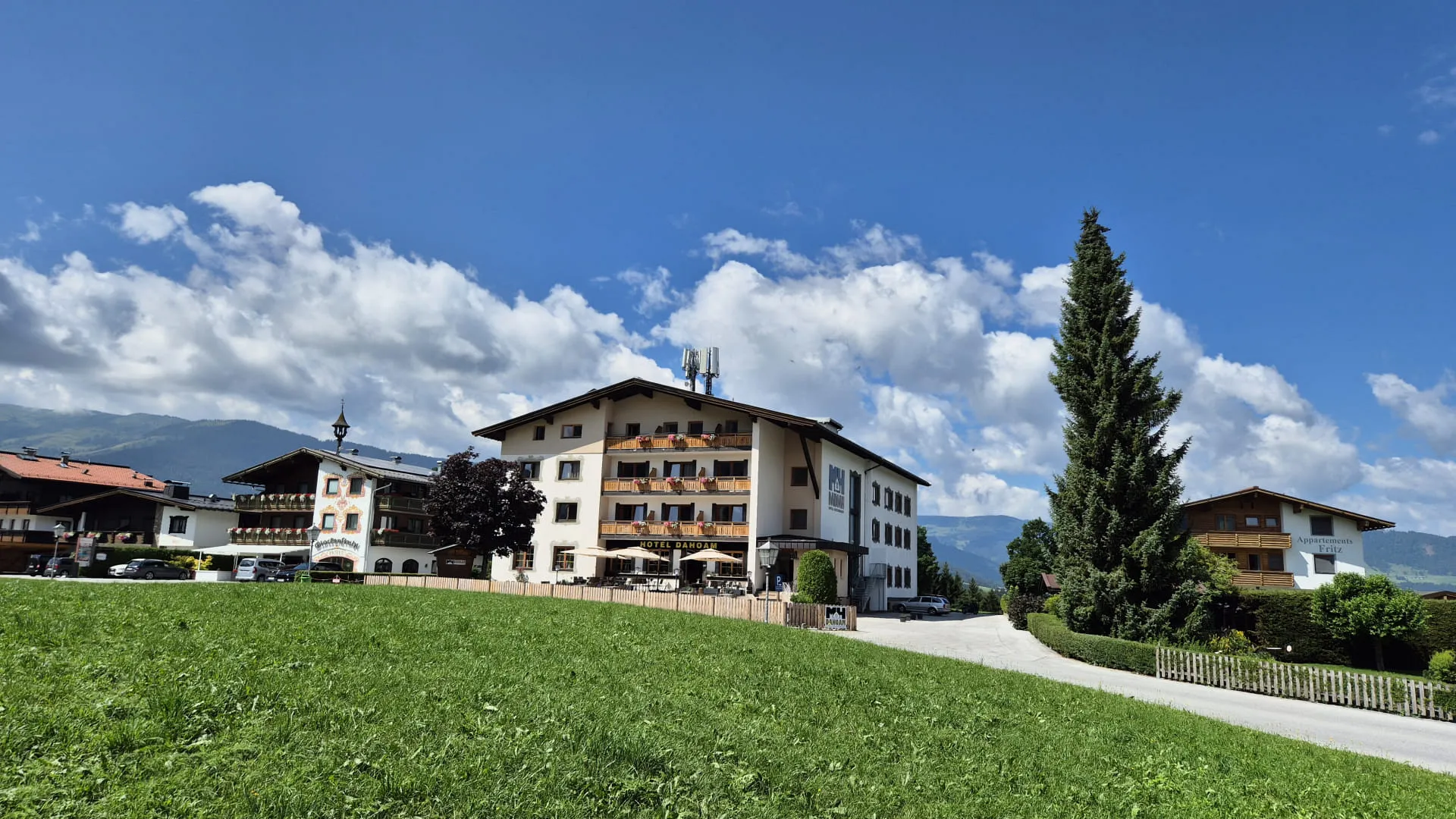 Sommeransicht eines Hauses mit grüner Wiese