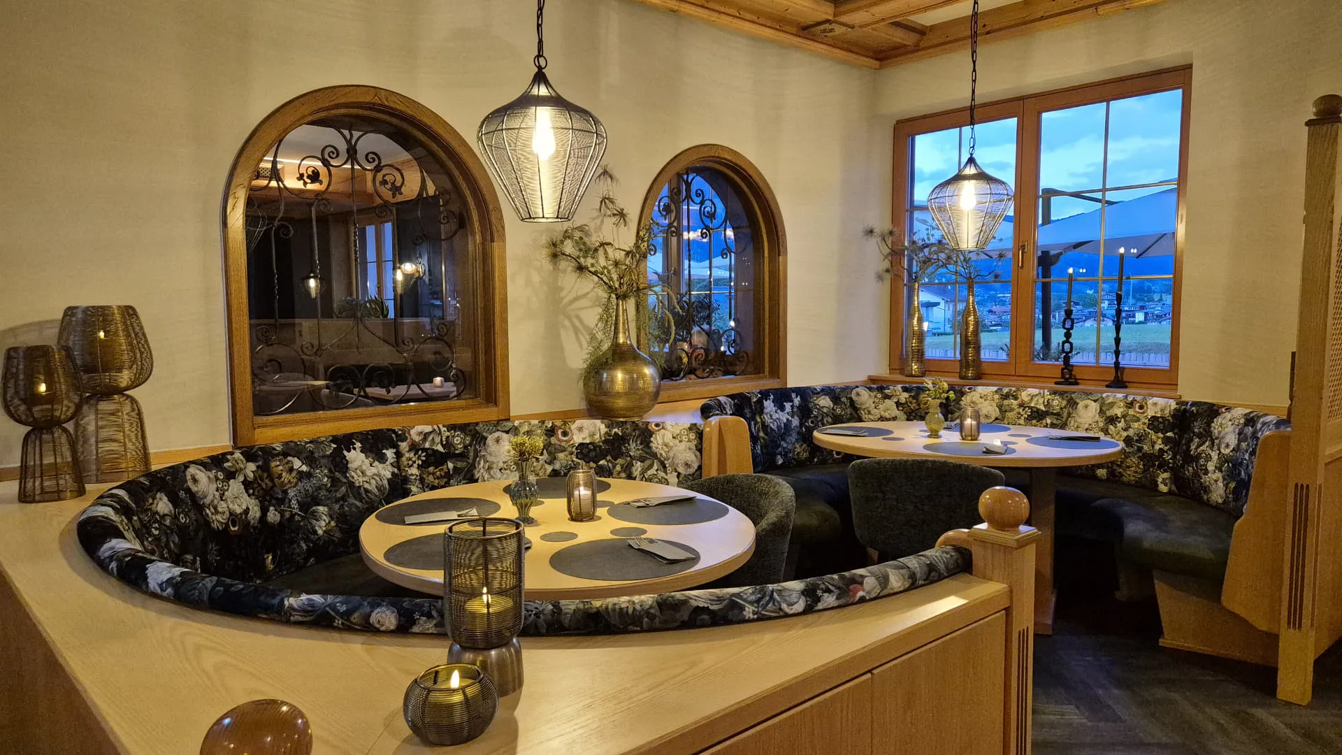 Gemütliches Restaurantinterieur mit runden Nischen und großen Fenstern